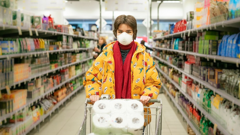 24.03.2020 Russia Saint Petersburg, a young woman in a store in a protective mask selects products