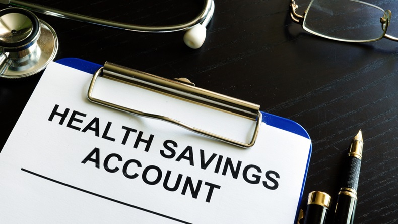 Health savings account HAS form in a clipboard.