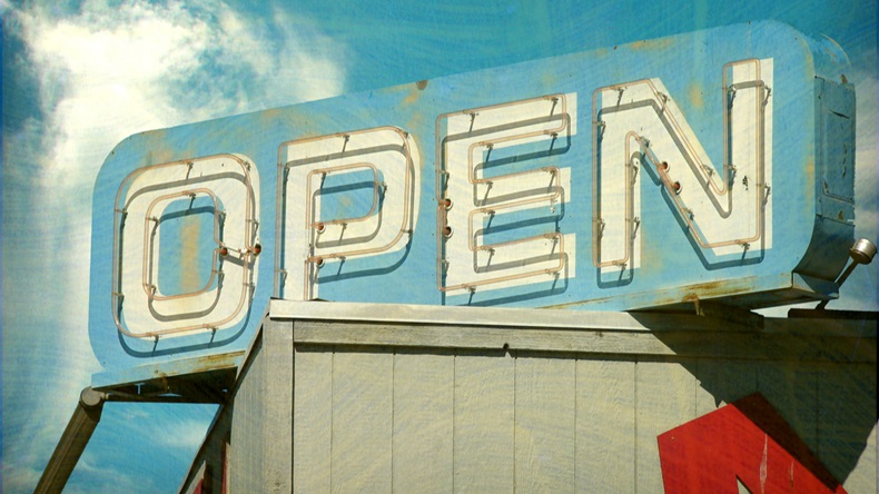 aged and worn vintage photo of open sign