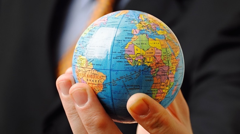 Businessman Holding a Globe in His Hand