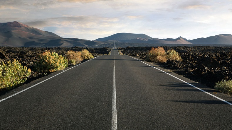 Empty endless highway through the volcanic landscape with copy space