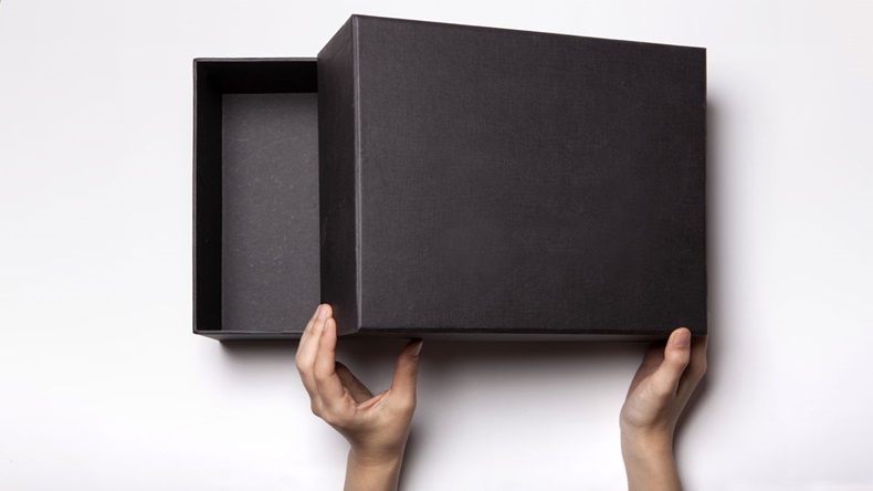 A female(woman, girl) two hands hold and open the empty(blank) black box isolated white, top view at the studio.