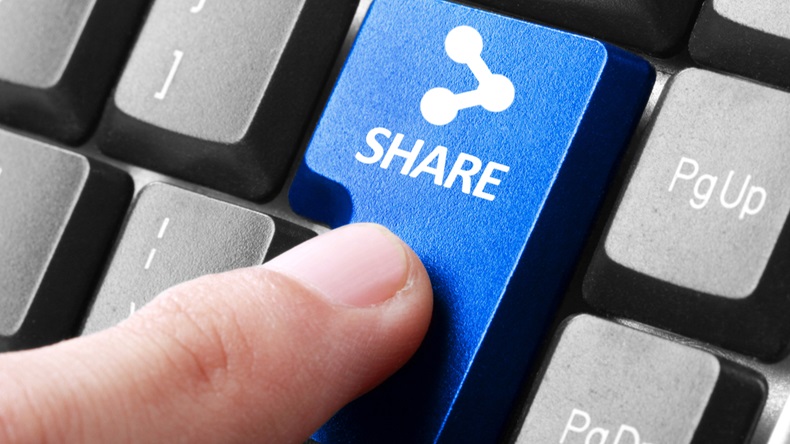Sharing file. gesture of finger pressing share button on a computer keyboard