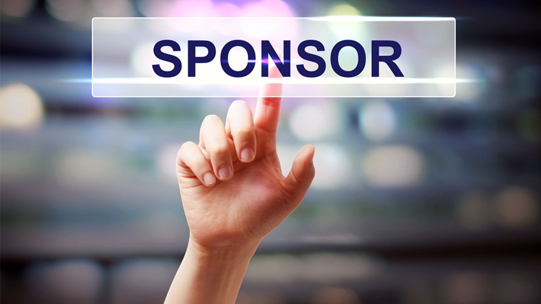 Sponsor concept with hand pressing a button on blurred abstract background